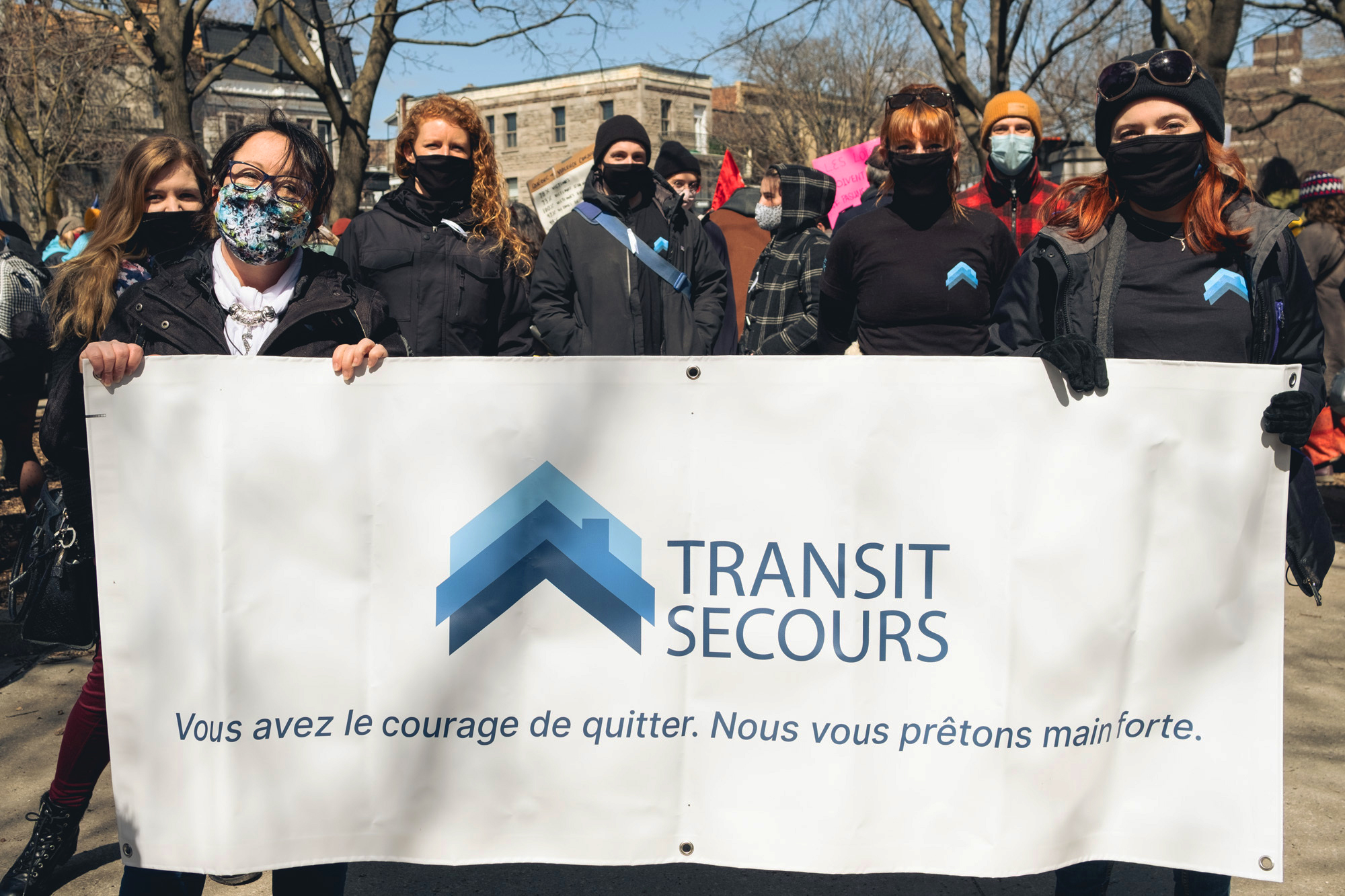 Women holding Transit Secours sign