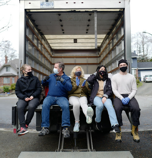 volunteers sitting in back of the truck