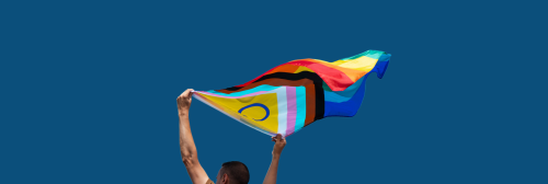 Person holding progressive pride flag